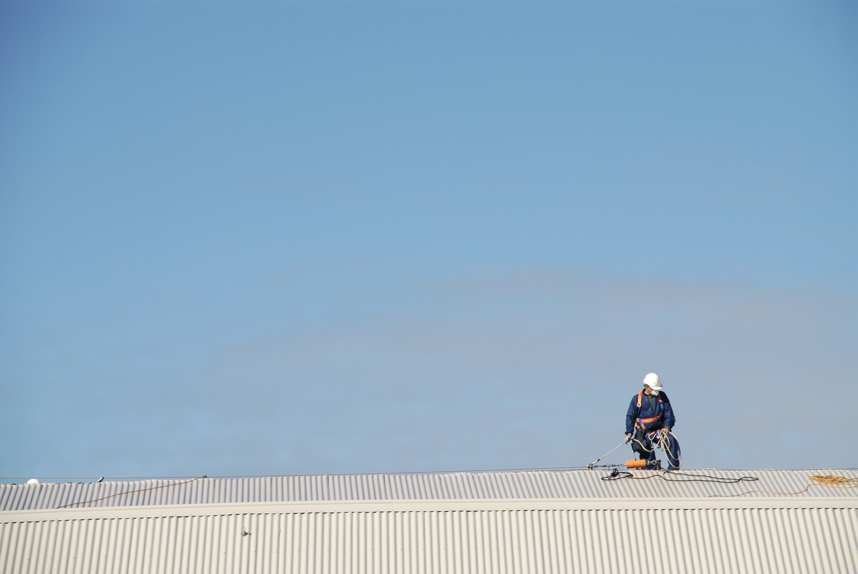 Roofer using harness on roof