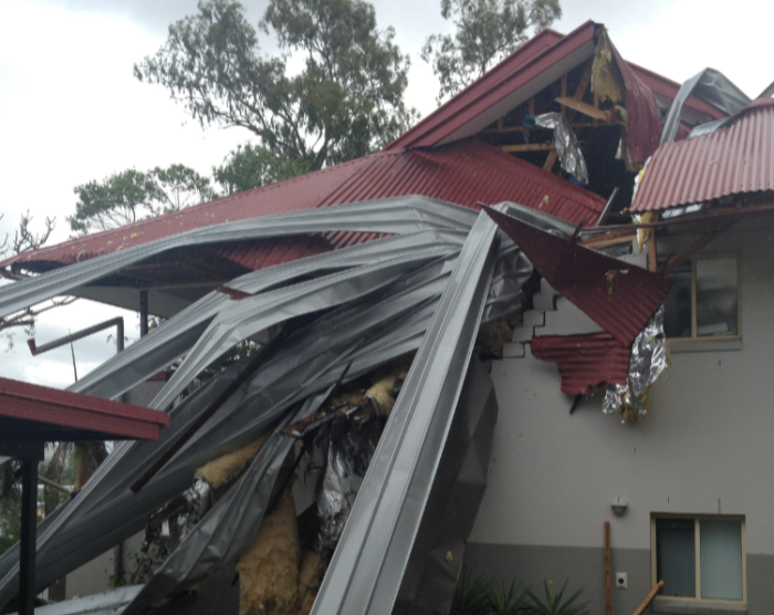 Storm damaged roof - twisted metal sheets