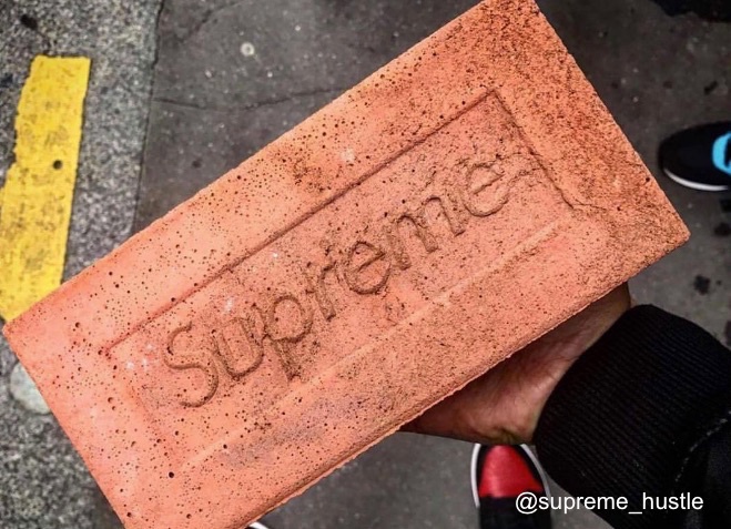 brick with supreme logo