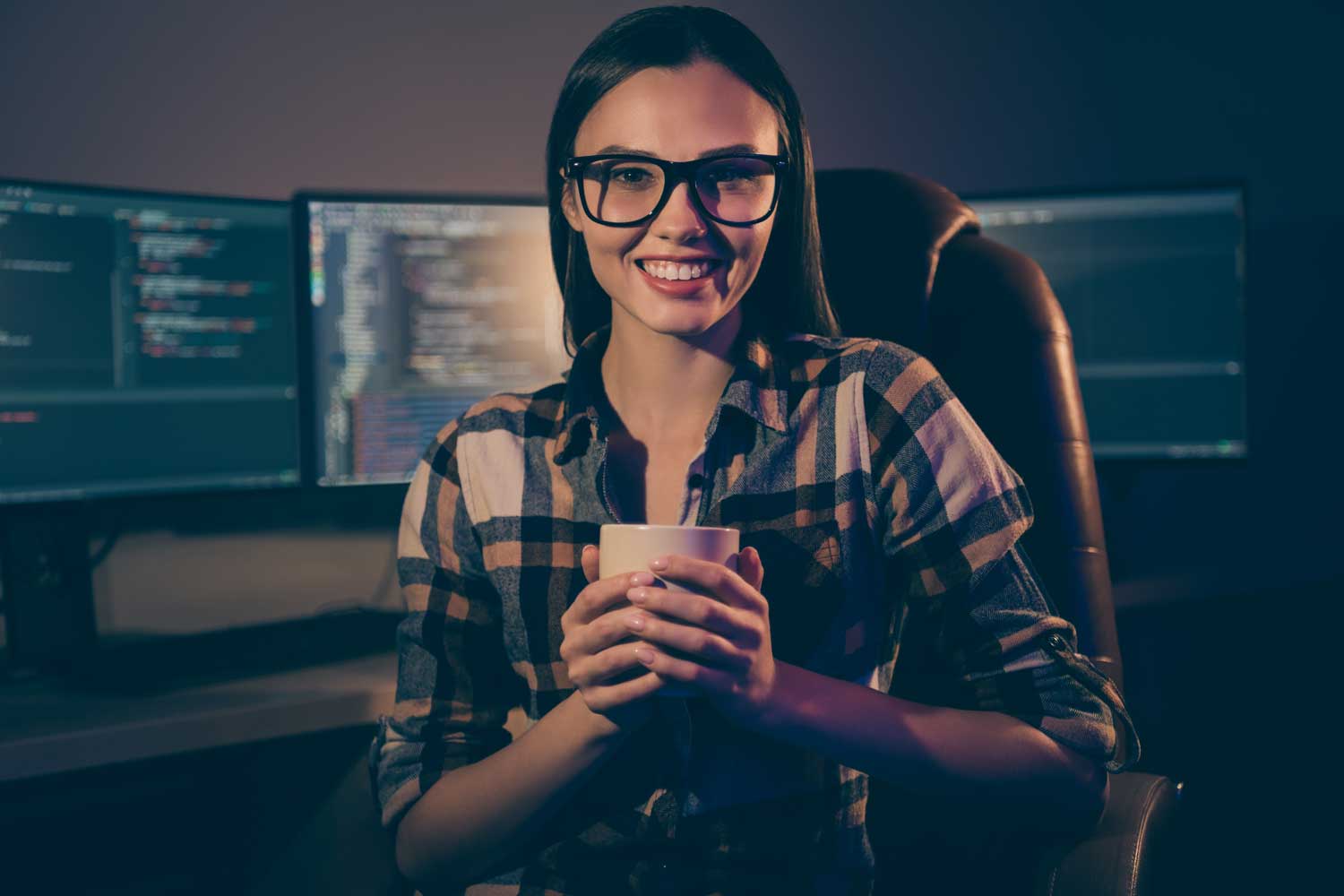 Learning People | Woman coding at desk with coffee