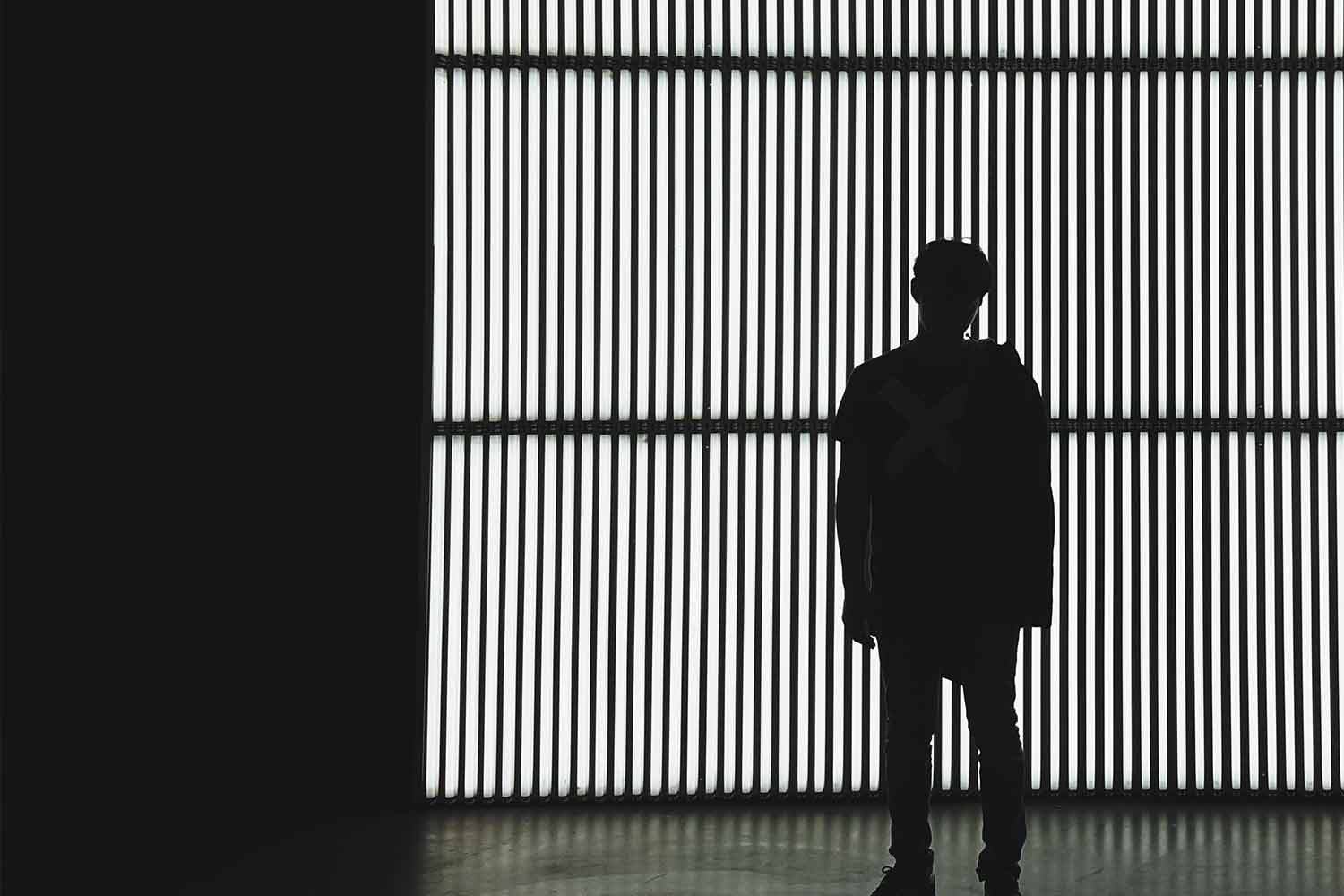 silhouette of a man against striped background