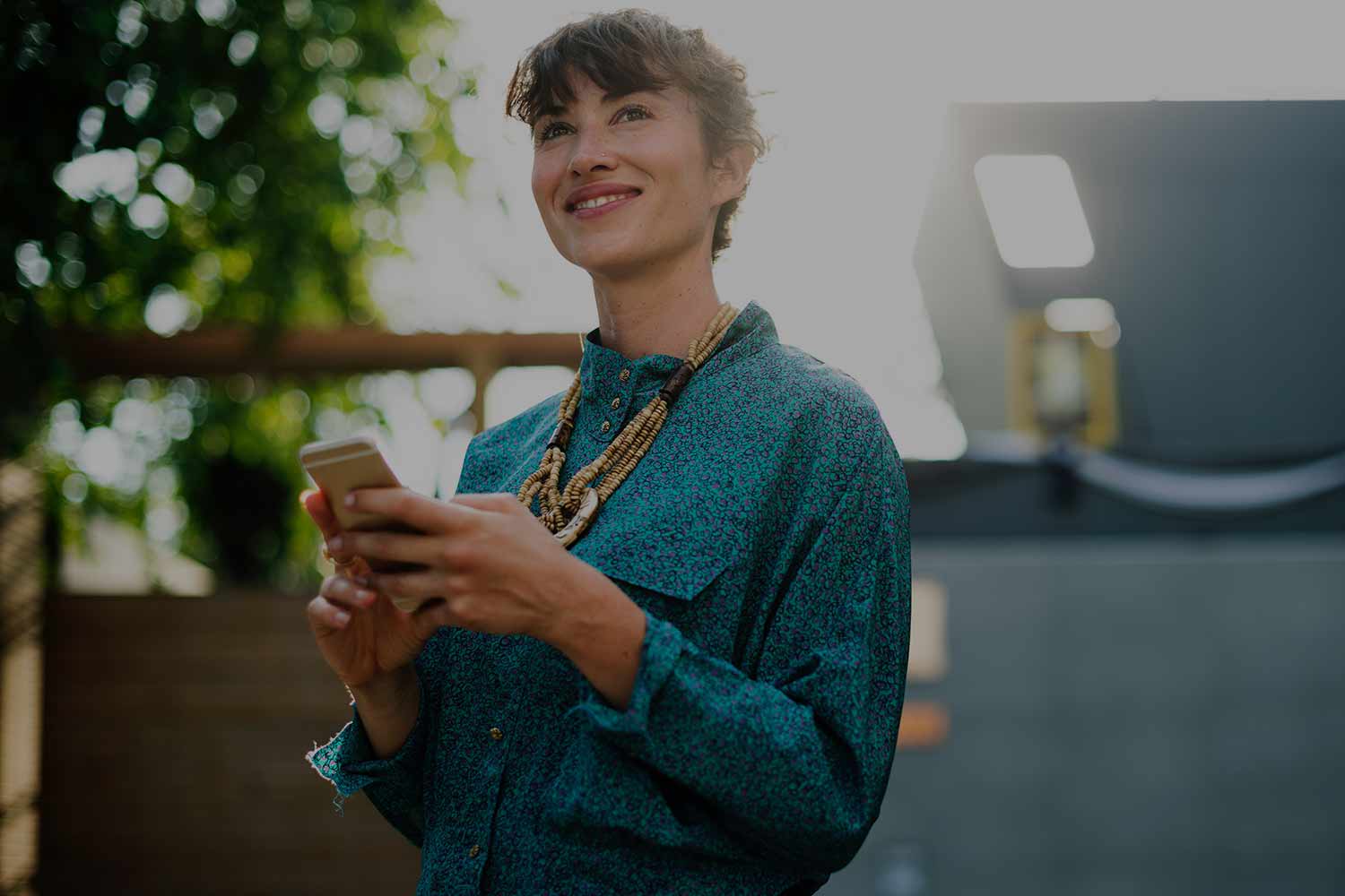 woman-smiling-with-phone-in-hand.jpg