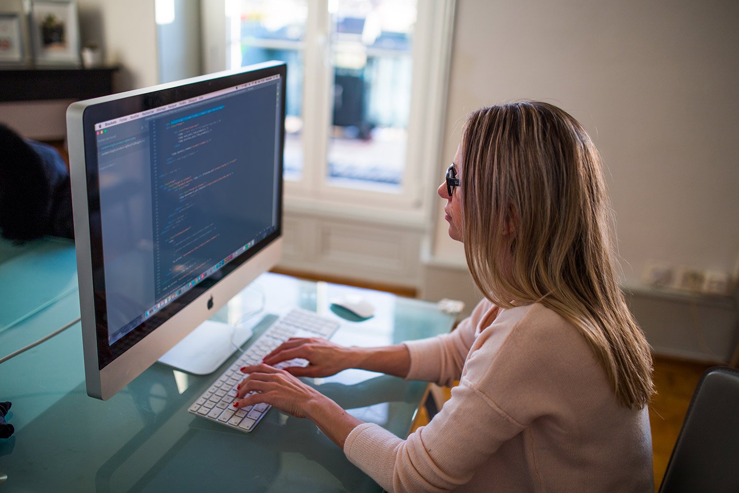 Learning People | Woman coding on desktop