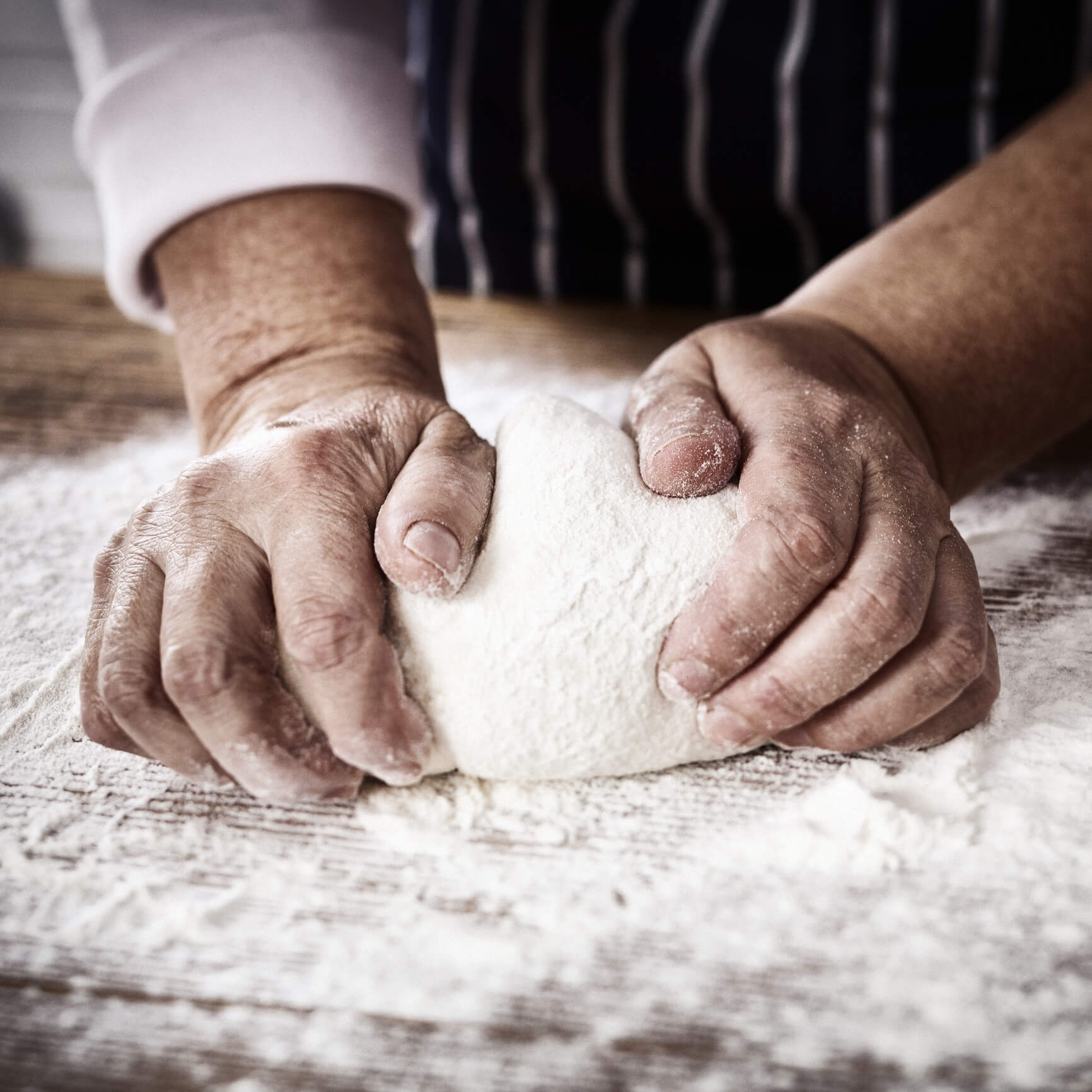 Baker with Bare Hands Kneading Dough
