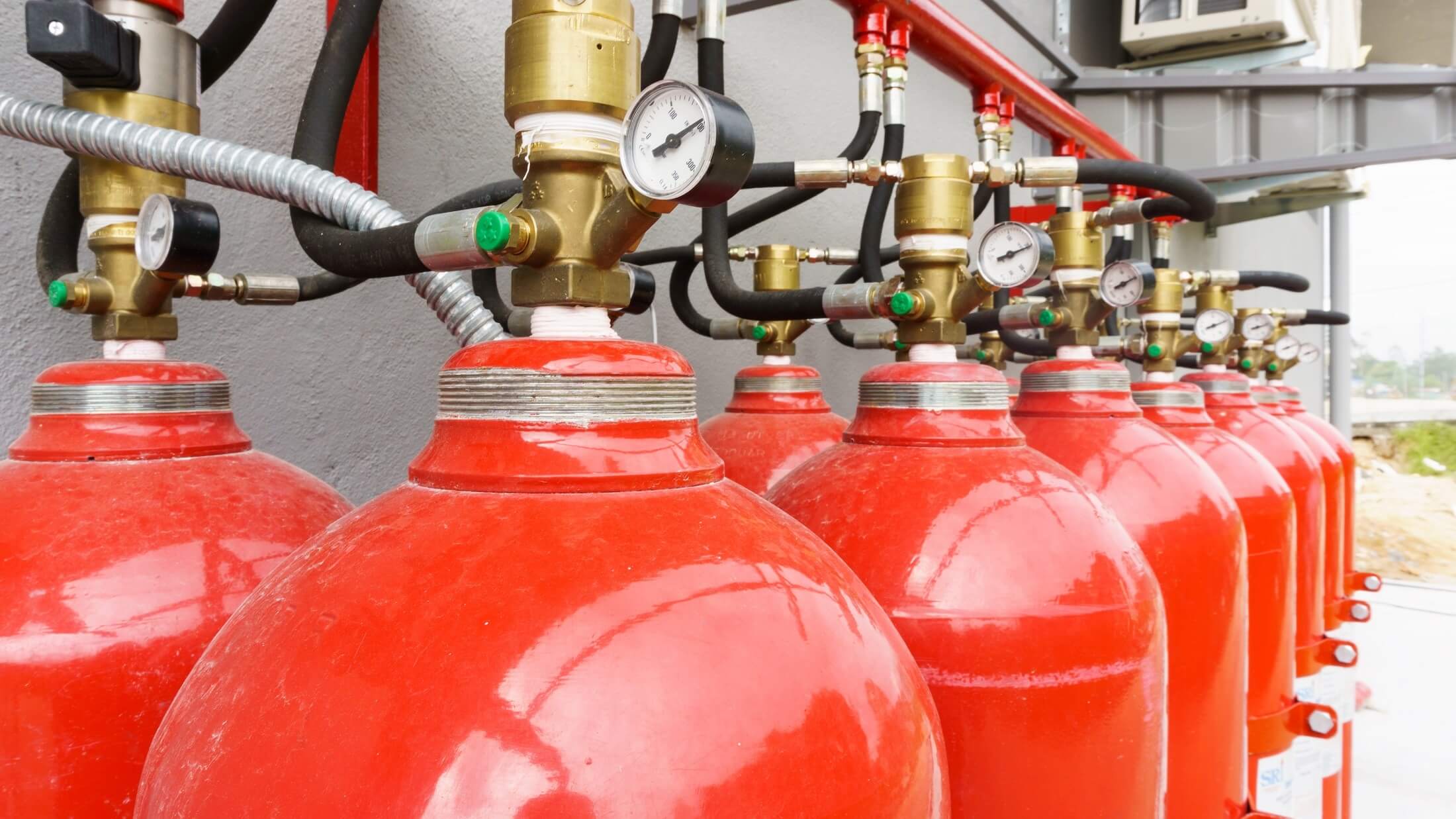 Red gas cylinder dangerously close to fire Vector Image