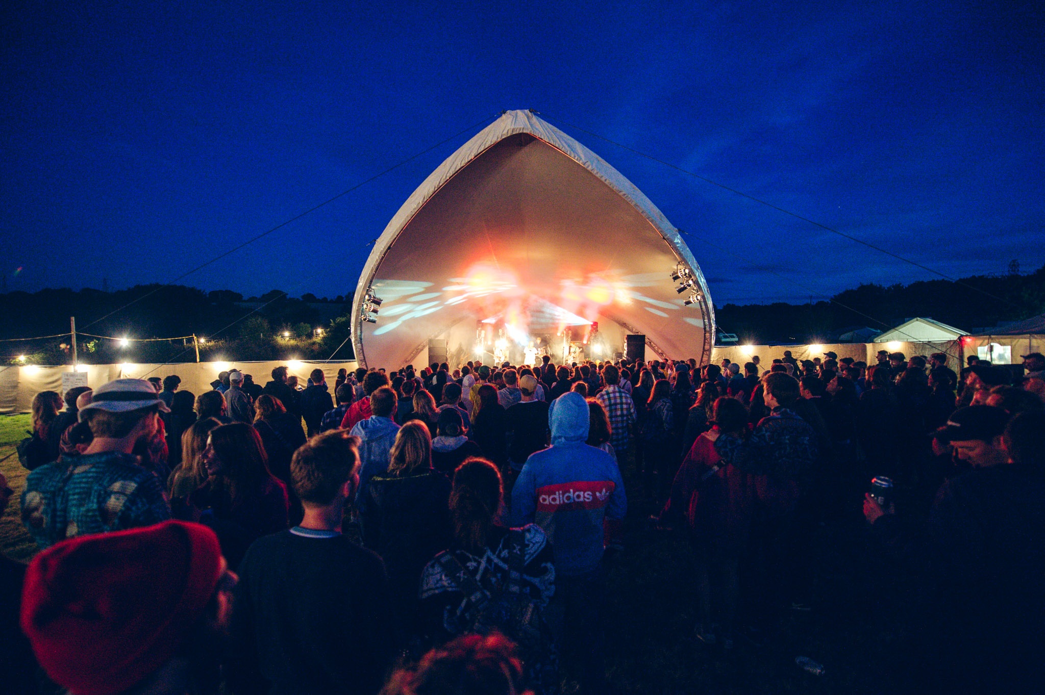 A crowd gathering round the main stage in the early evening.