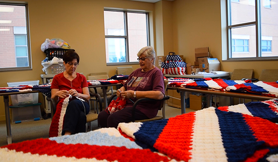 Photo of Lake Health volunteers Iris and Susan crafting blankets to donate to hospitalized veterans