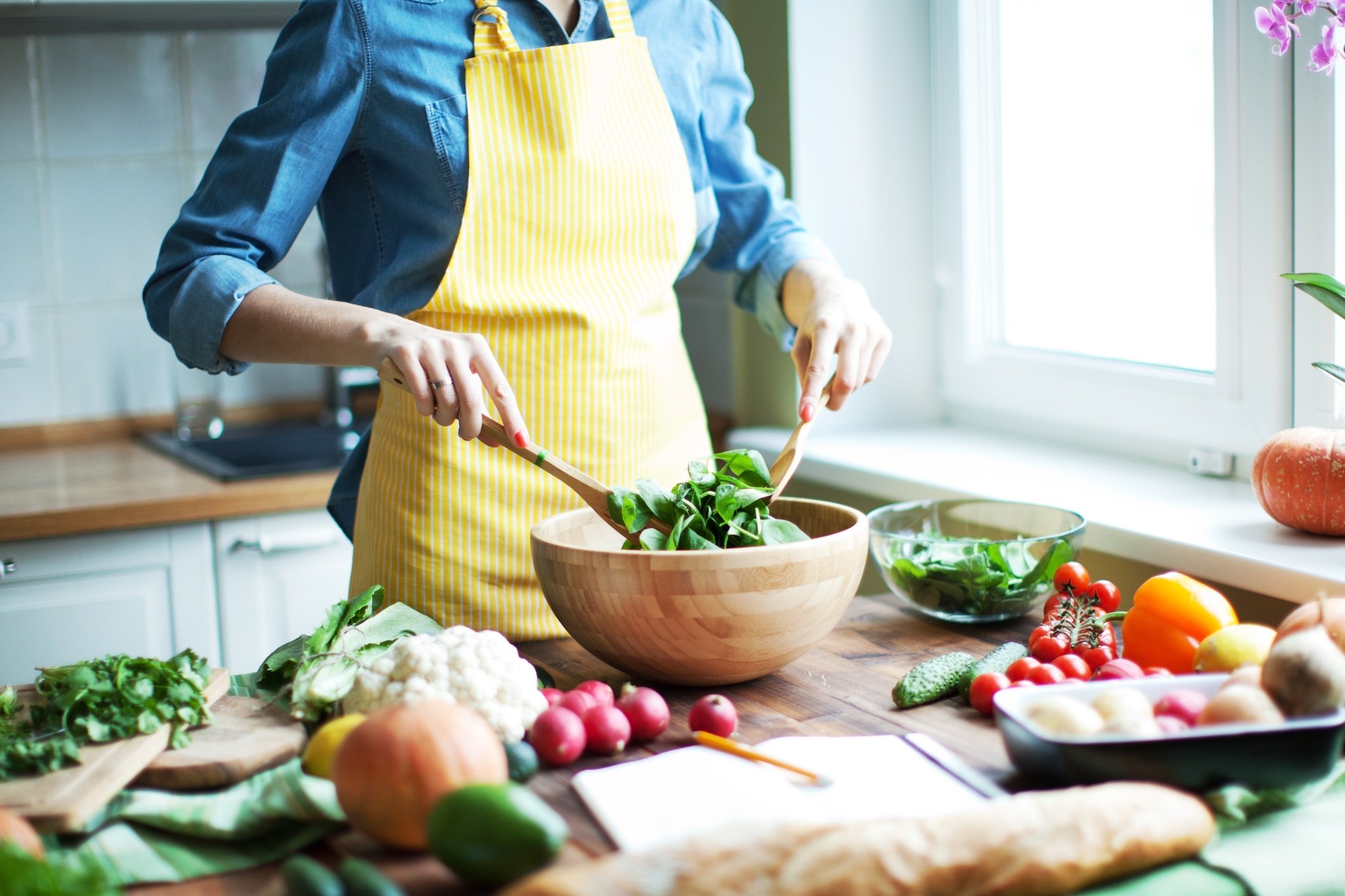 A woman preparing a healthy salad