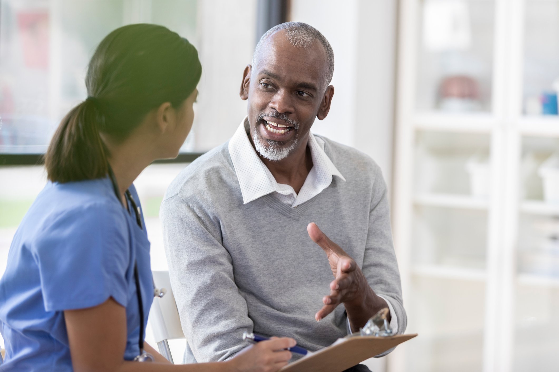 A patient talking to his nurse before surgery