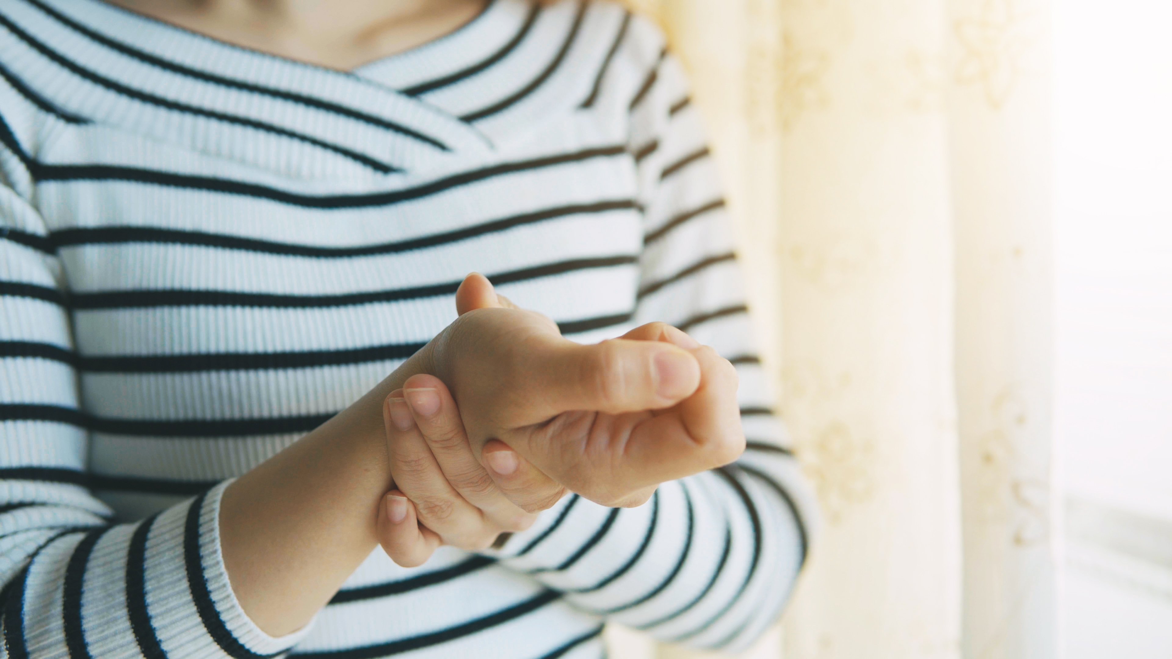 A woman with joint pain in her wrist