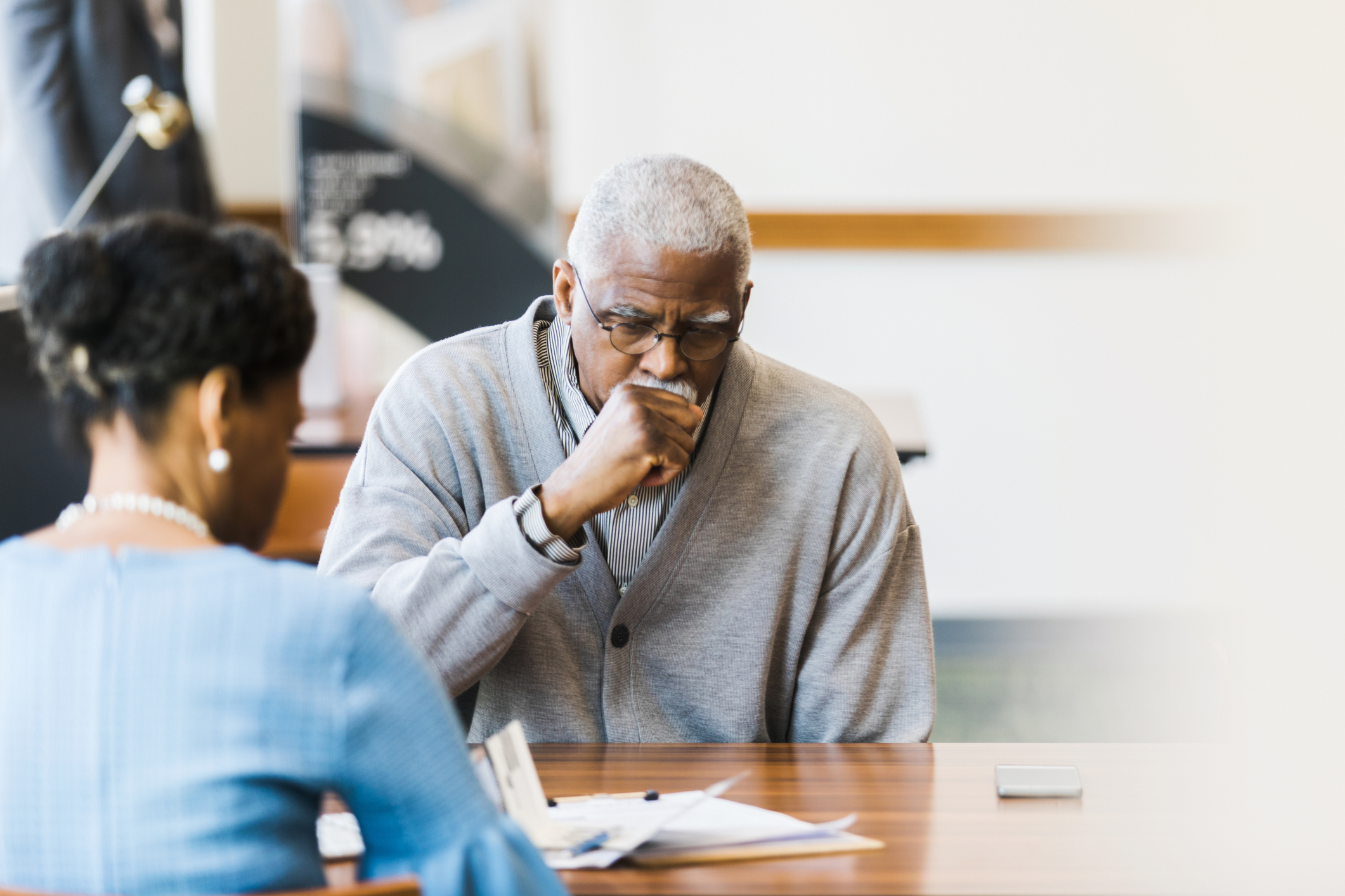 An older man coughing