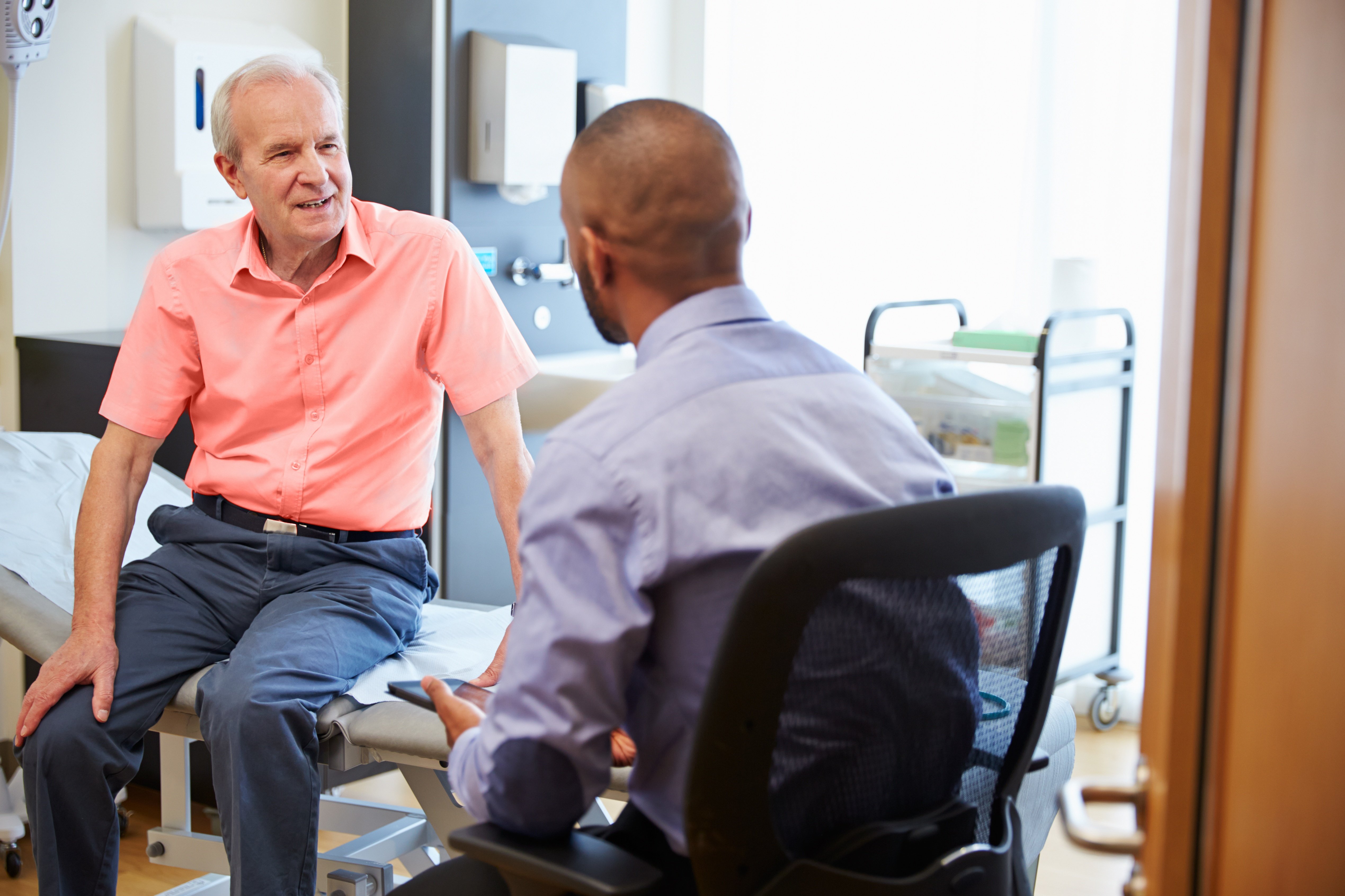 Older man talking with his doctor