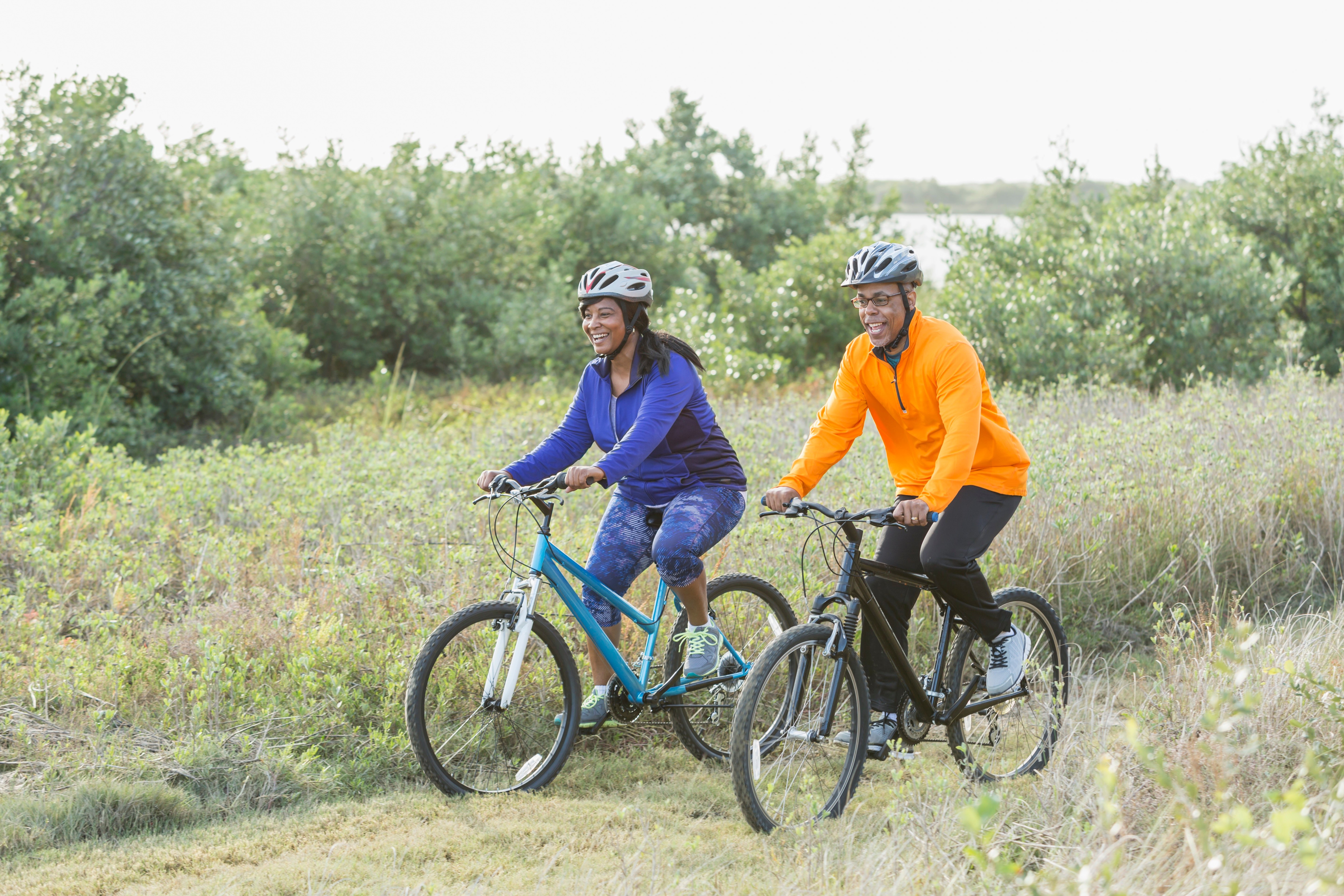 African-american couple riding bikes outside