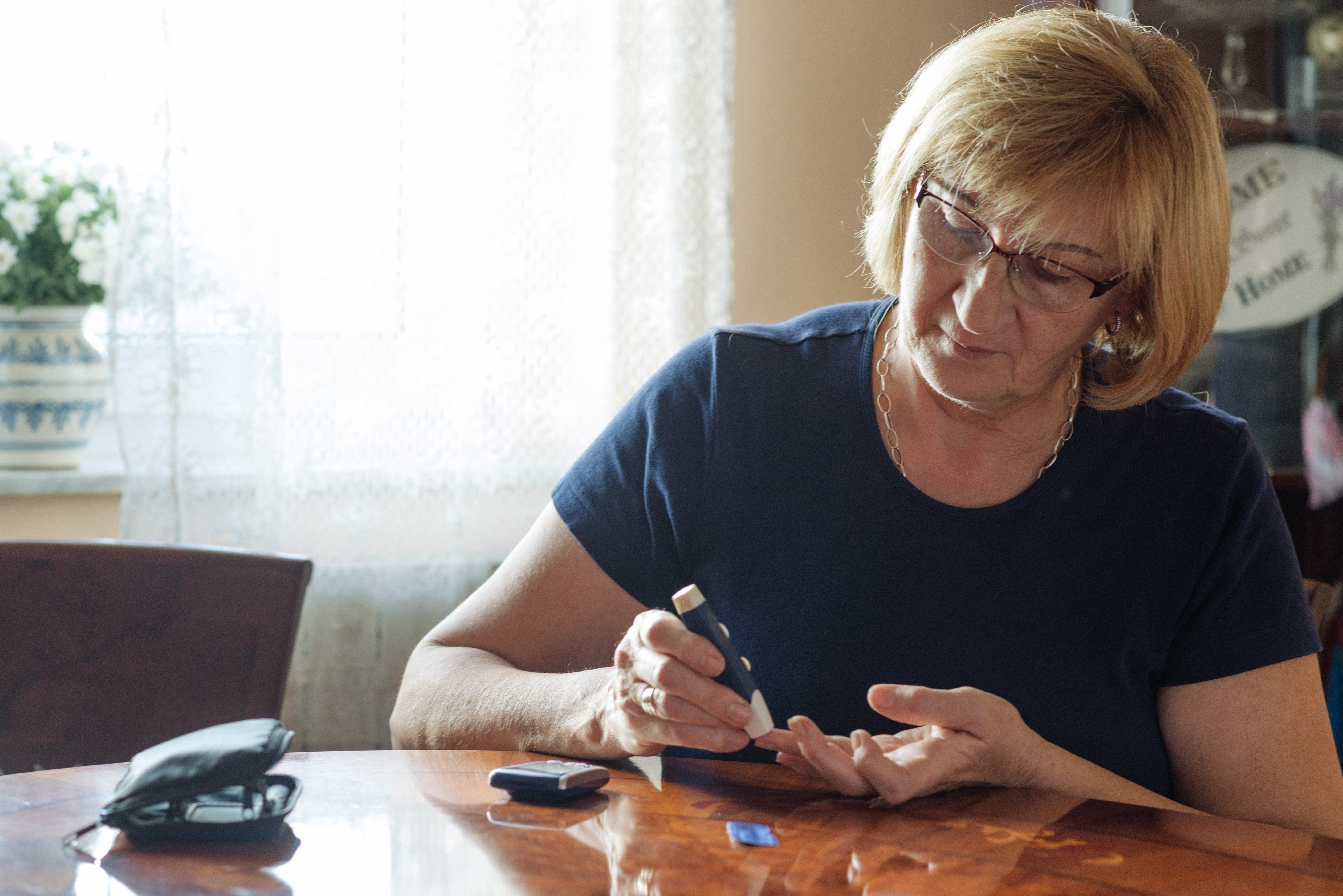 Older woman treating herself for diabetes