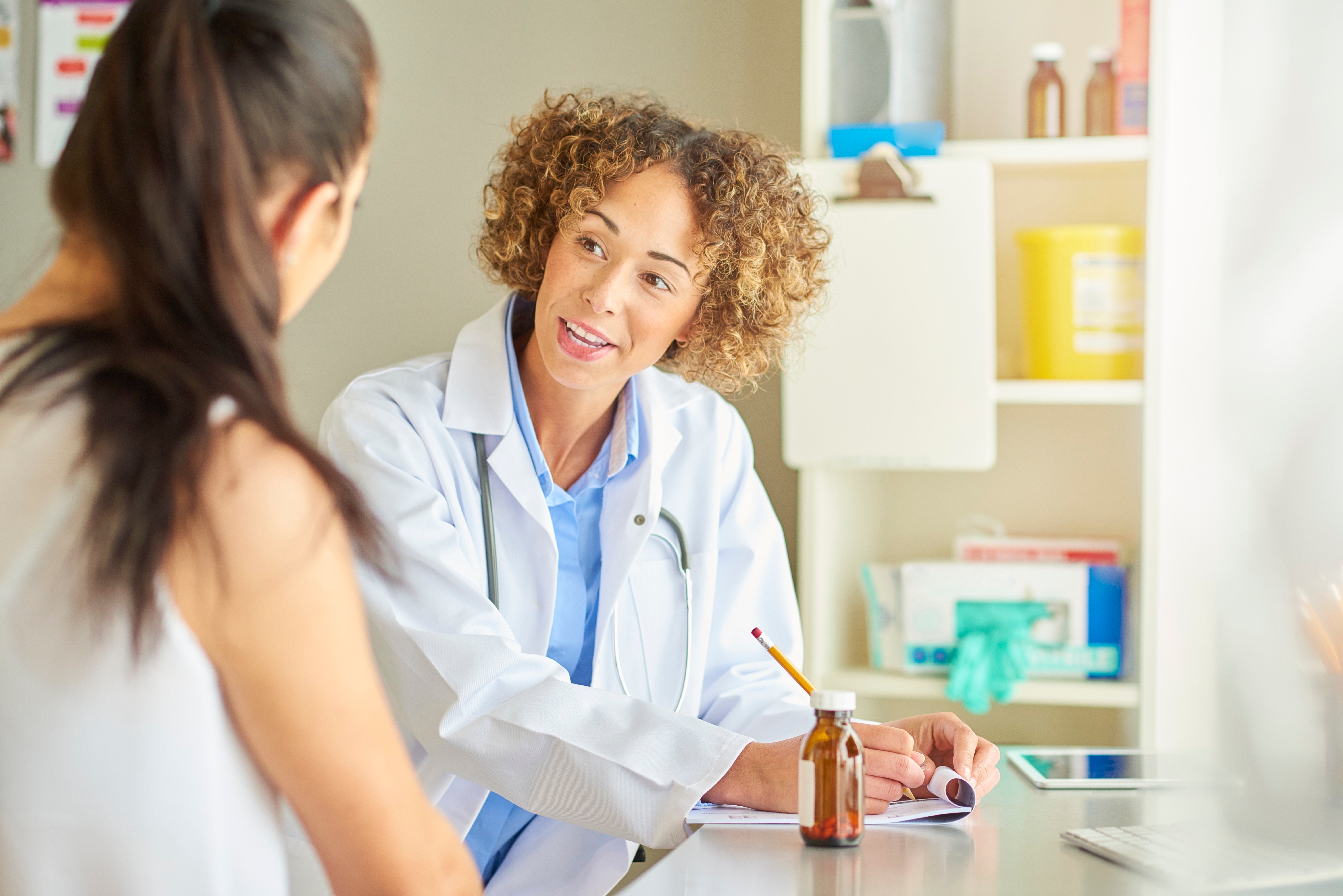 A woman and doctor reviewing mammogram results