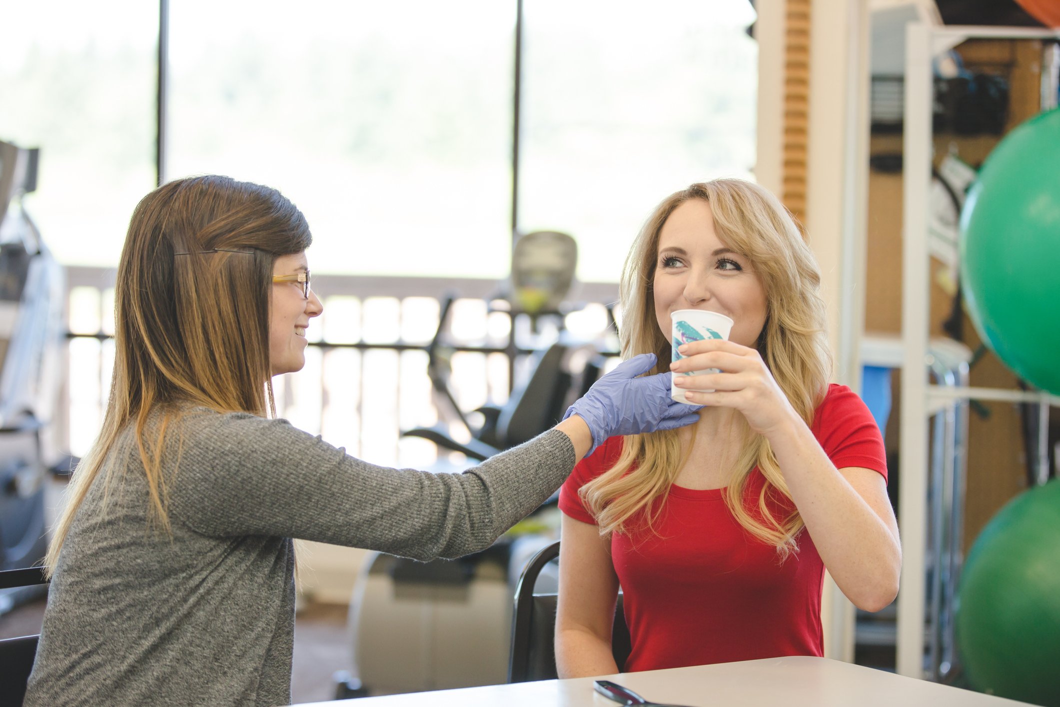 Female speech pathologist assisting adult patient