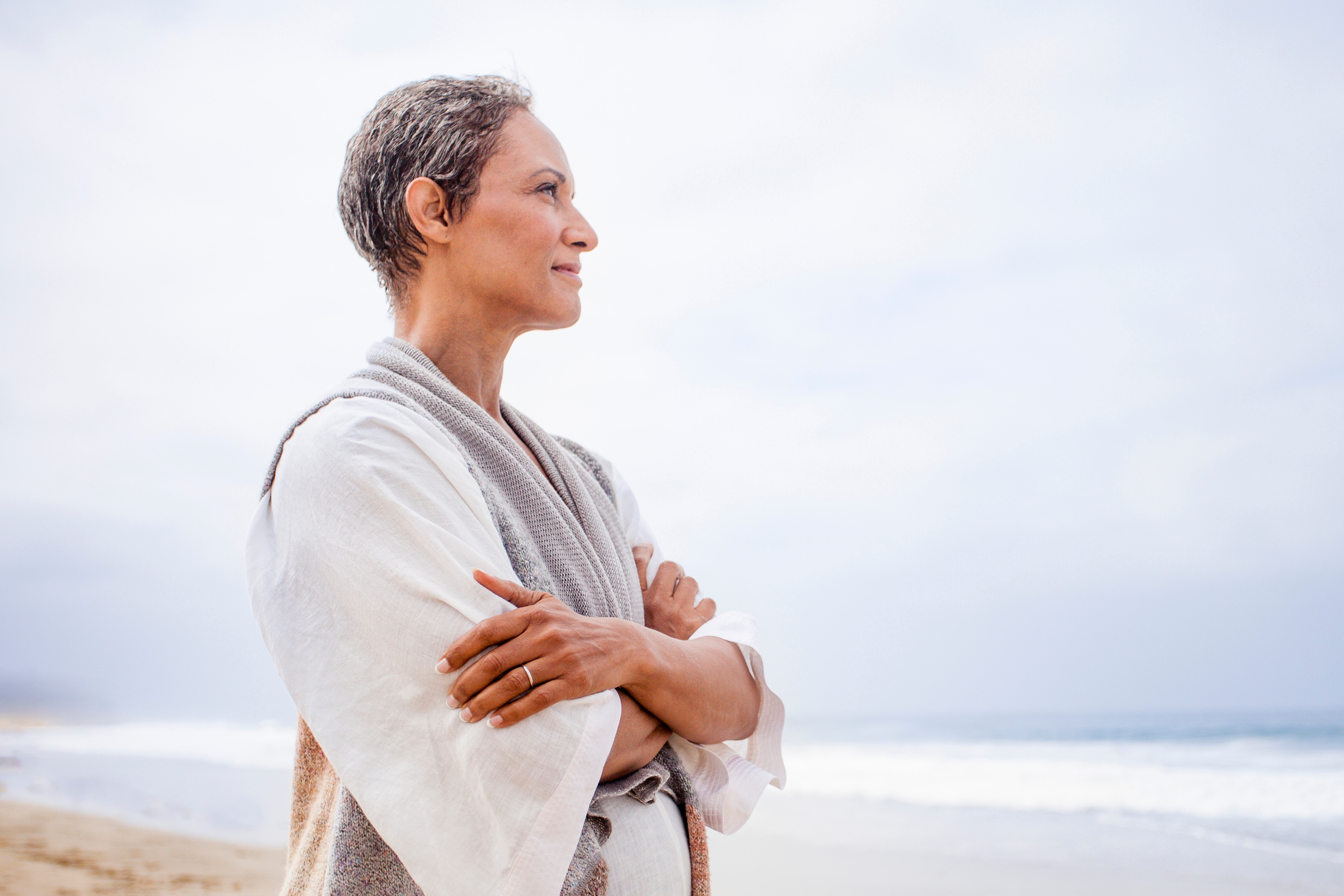 A woman in her 50's looking at the ocean