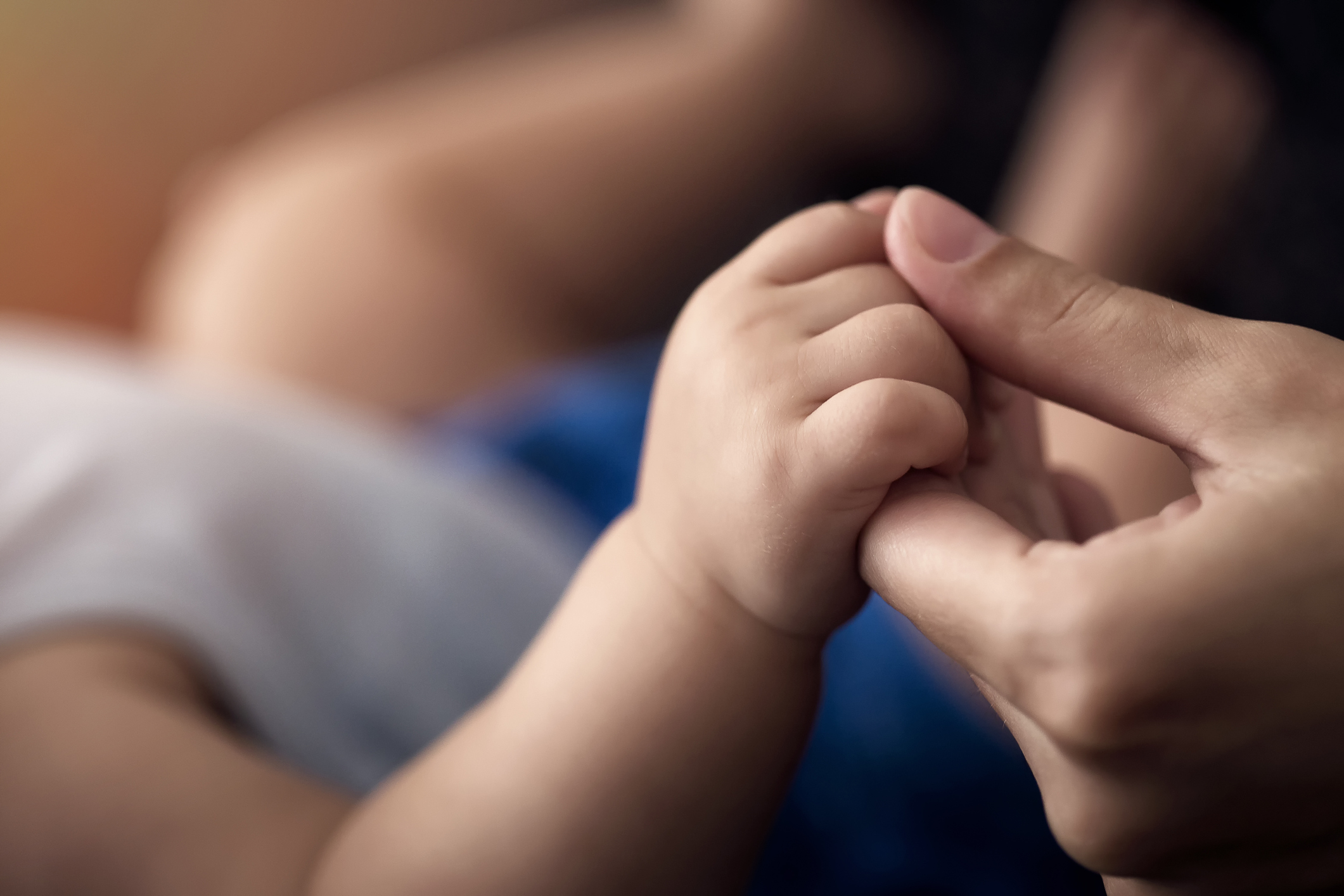 baby holding a mothers hand