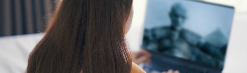 A girl watching Game of Thrones on her laptop.