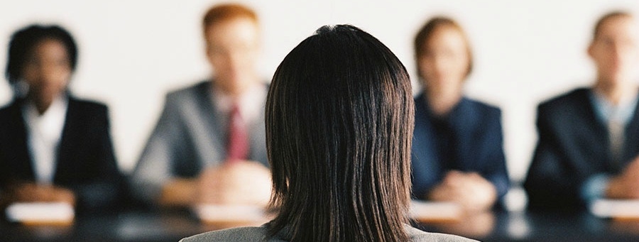 An individual interviewing in front of 4 employers.
