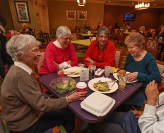 Senior friends eating dinner