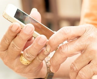 older woman handling a cell phone learning of the 10 smartphone exercise apps