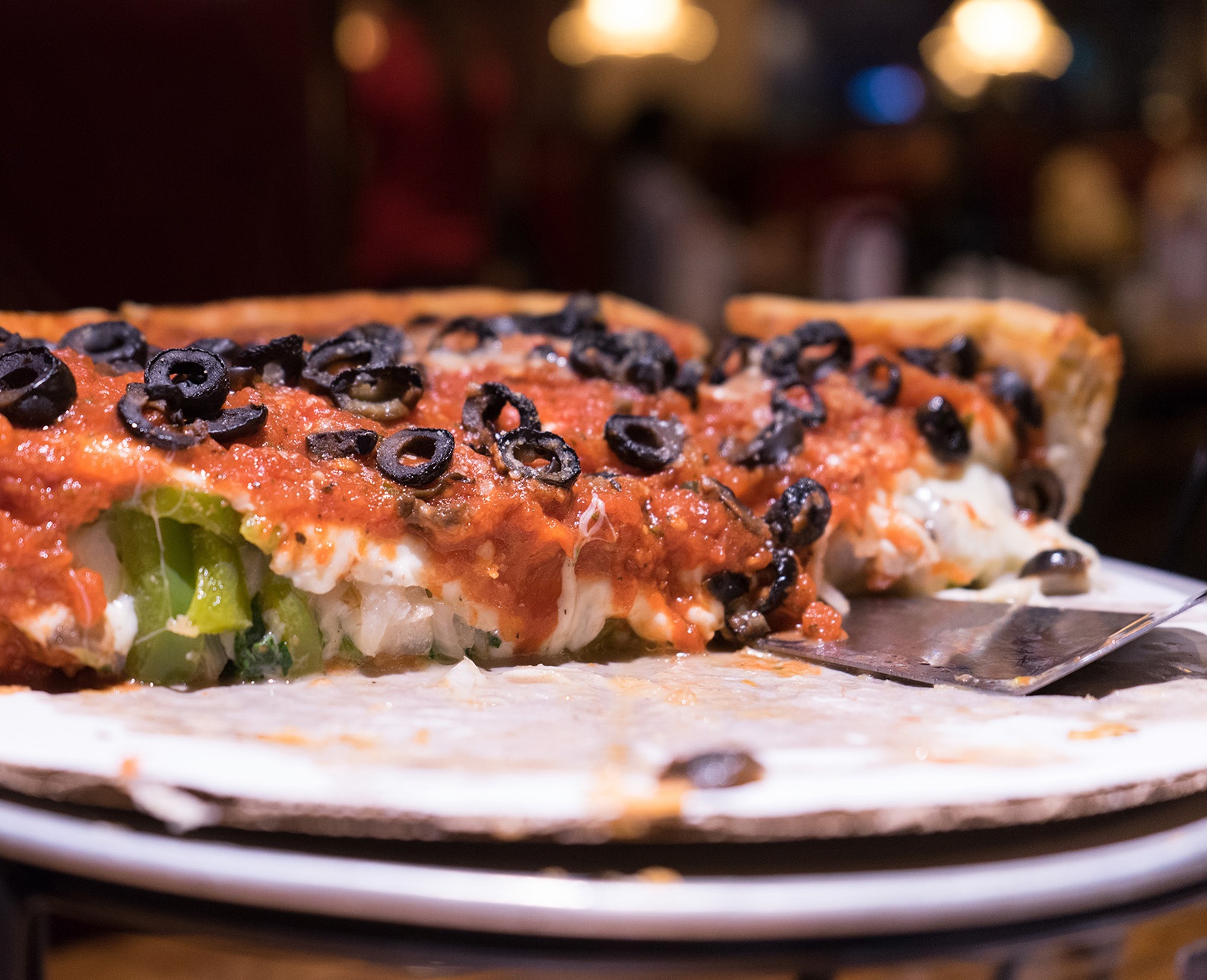 cheesy Chicago style deep dish pizza with olive toppings