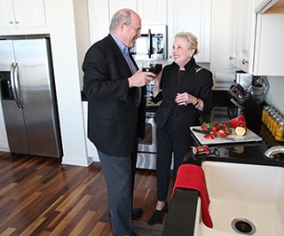 enjoying an appetizer with a spouse in the kitchen at a life plan community