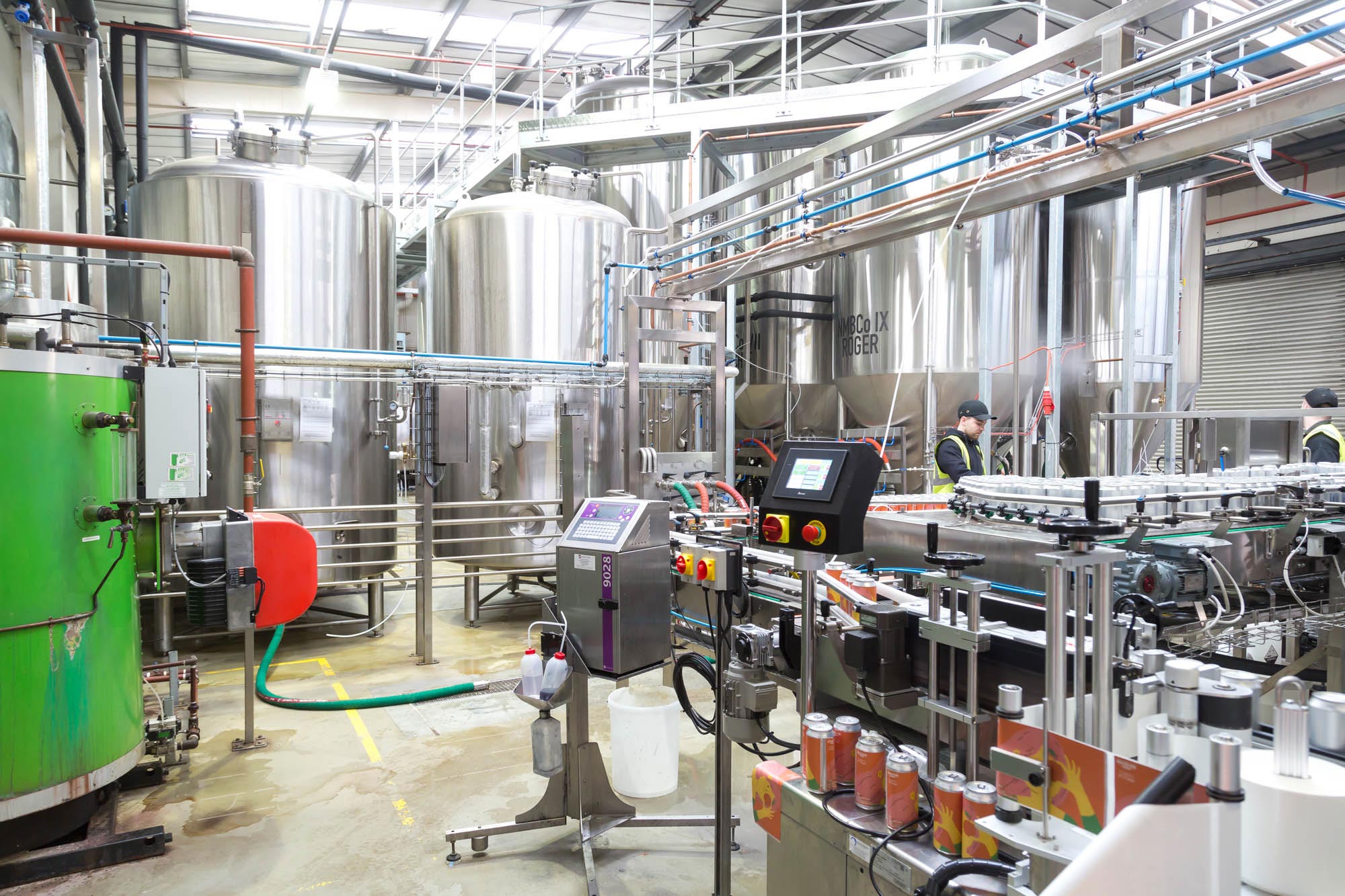interior image of Northern Monk brewery with various brewery equipment including a canning machine