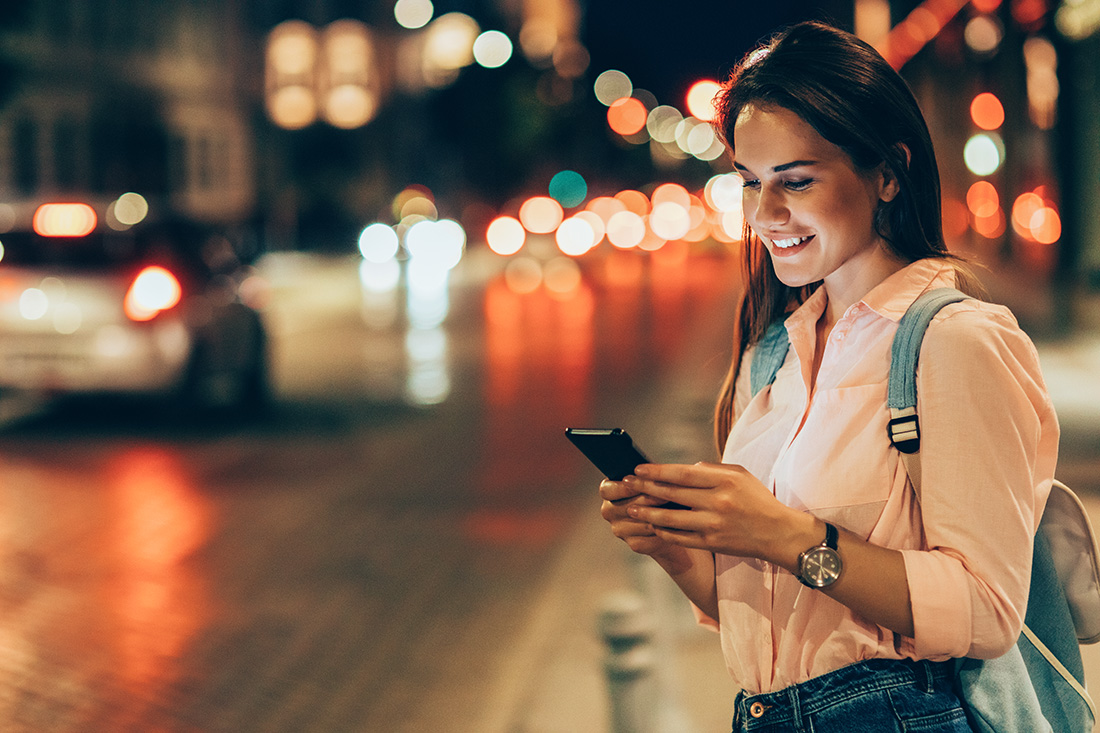 checking reward statement smartphone outside