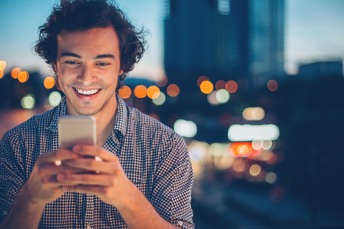 guy checking mobile outside