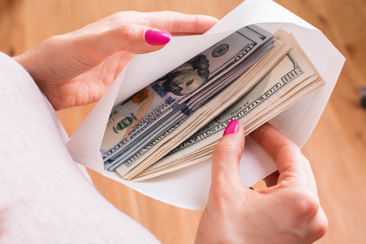 Woman holding envelope with money