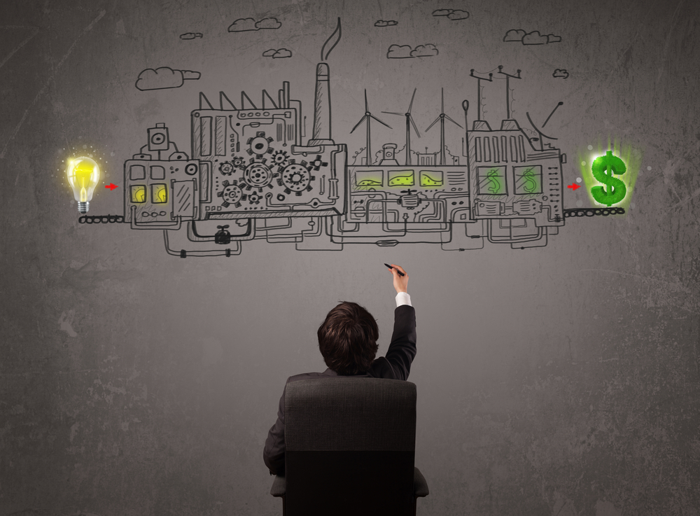 Business man looking at factory that makes money from ideas concept