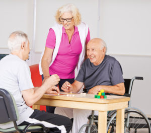 Happy senior people playing Bingo together in a nursing home