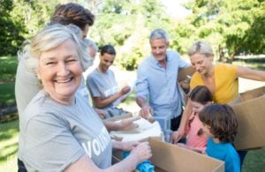 Happy volunteer family separating donations stuffs on a sunny da