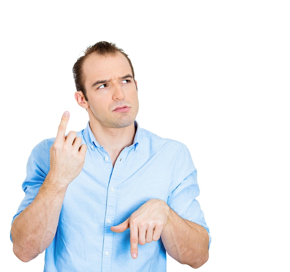 Closeup portrait confused young business man pointing in two different directions, not sure which way to go life, hesitant to make decision isolate white background. Emotion, facial expression feeling.jpeg