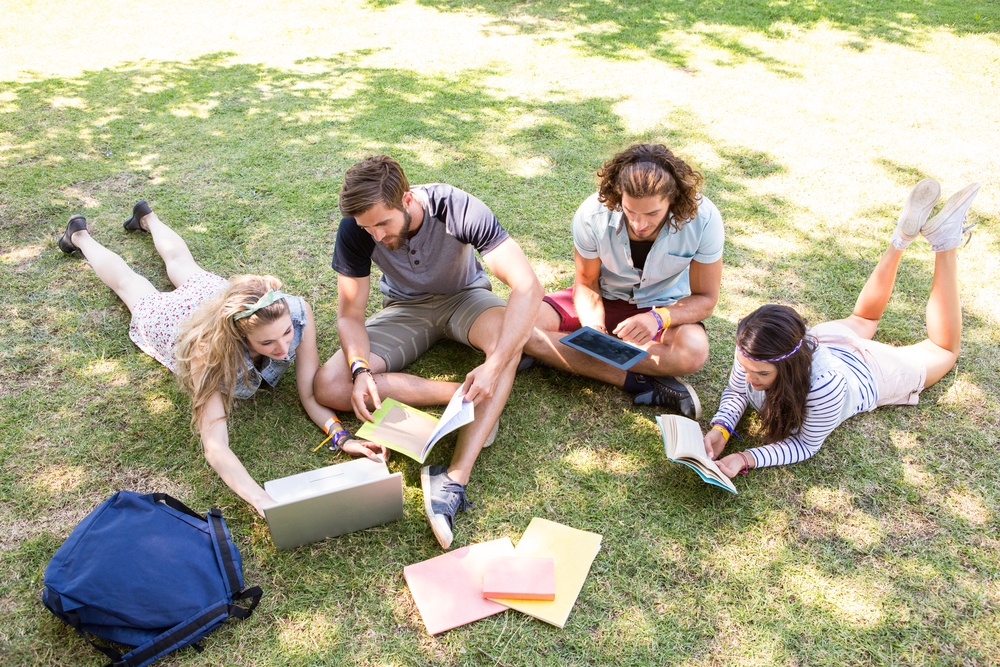 Classmates revising together on campus on a summers day