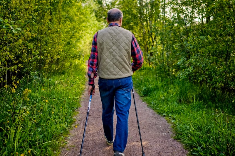 Man walking on a path outdoors.