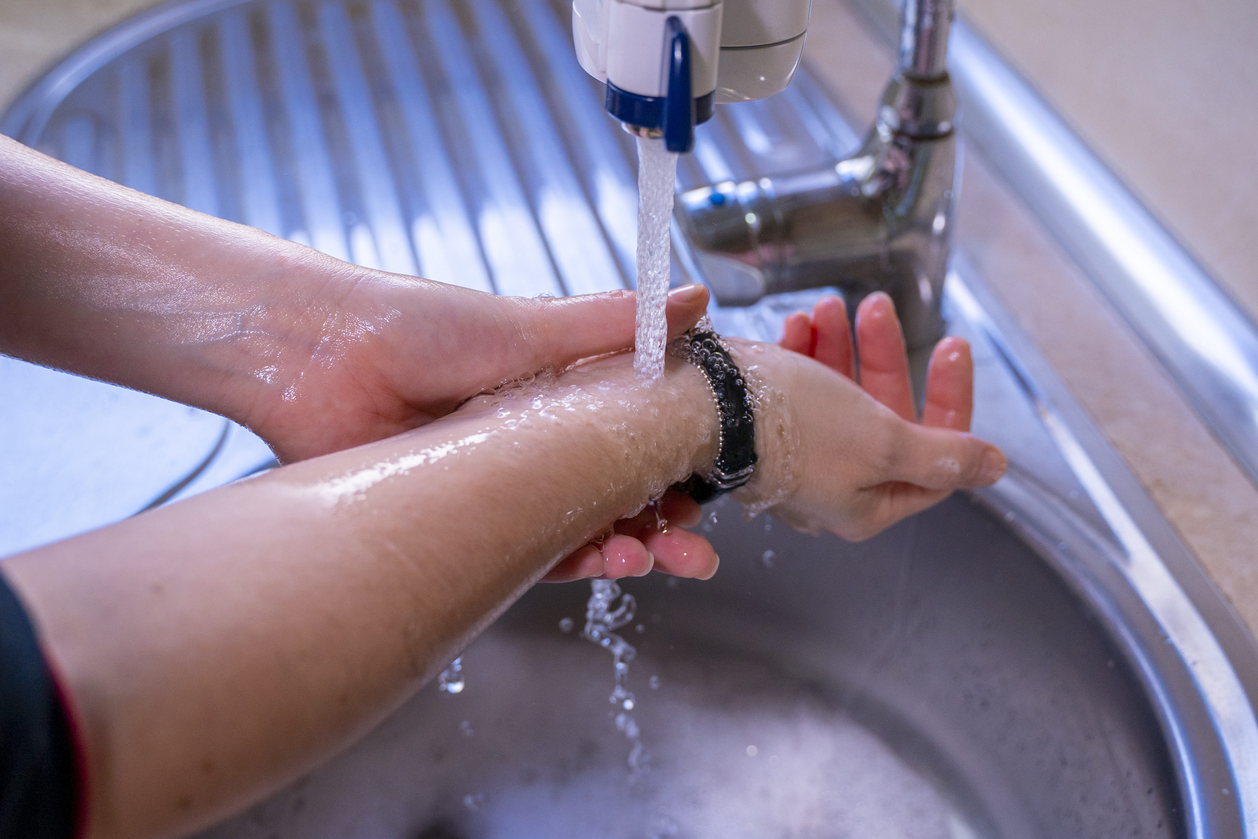 Person washing arms and hands.