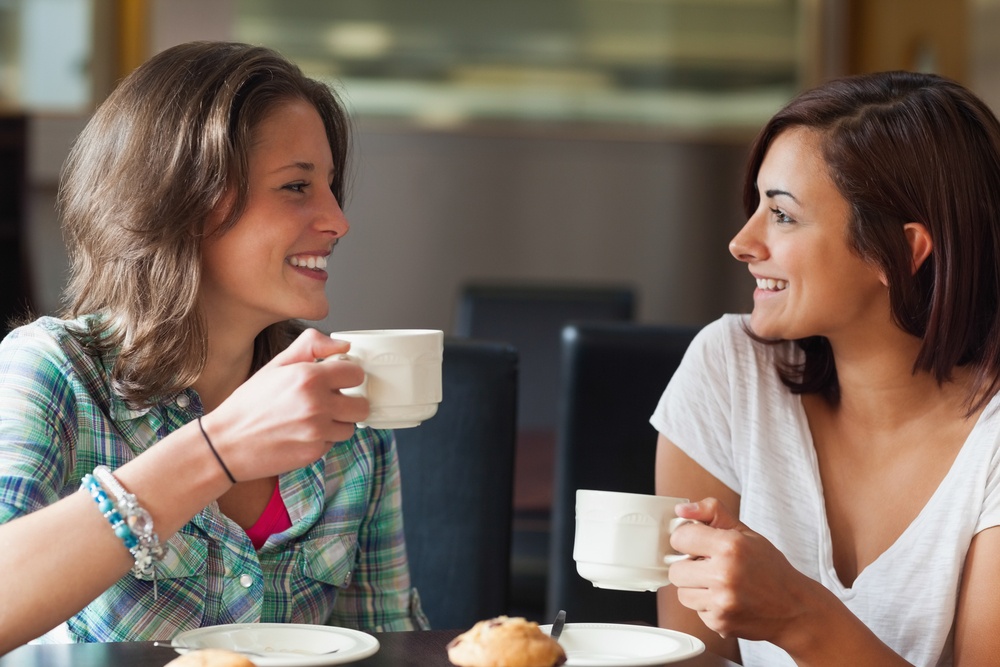 2 women having coffee: 5 Swedish values your expats should know about