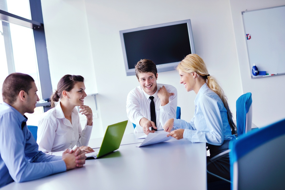 Group of happy young business people in a meeting at office.jpeg