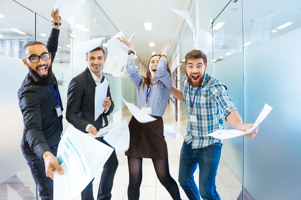 Group of joyful excited business people: What to do about expat happiness at the office