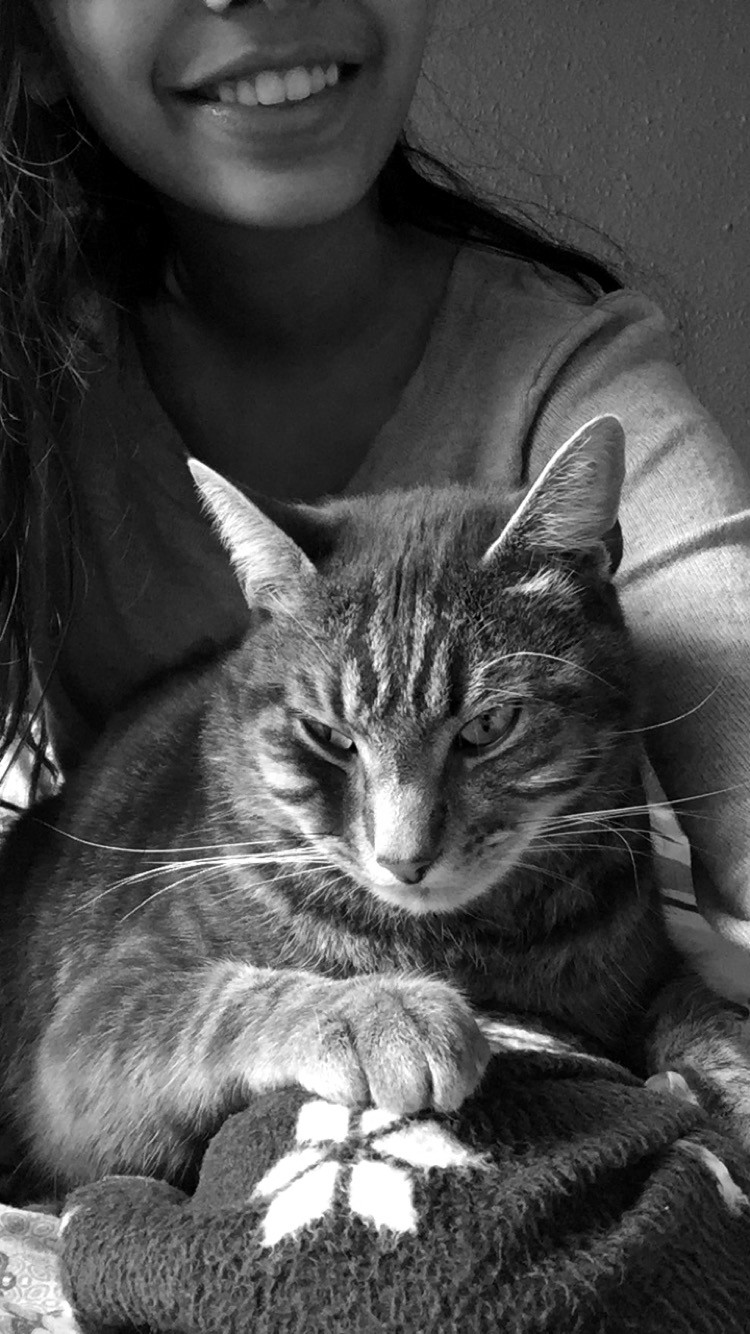 black and white photo of Harpreet and her cat Kitty