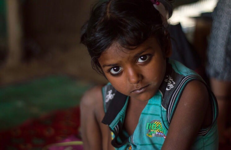 Young Indian girl sitting on the floor.