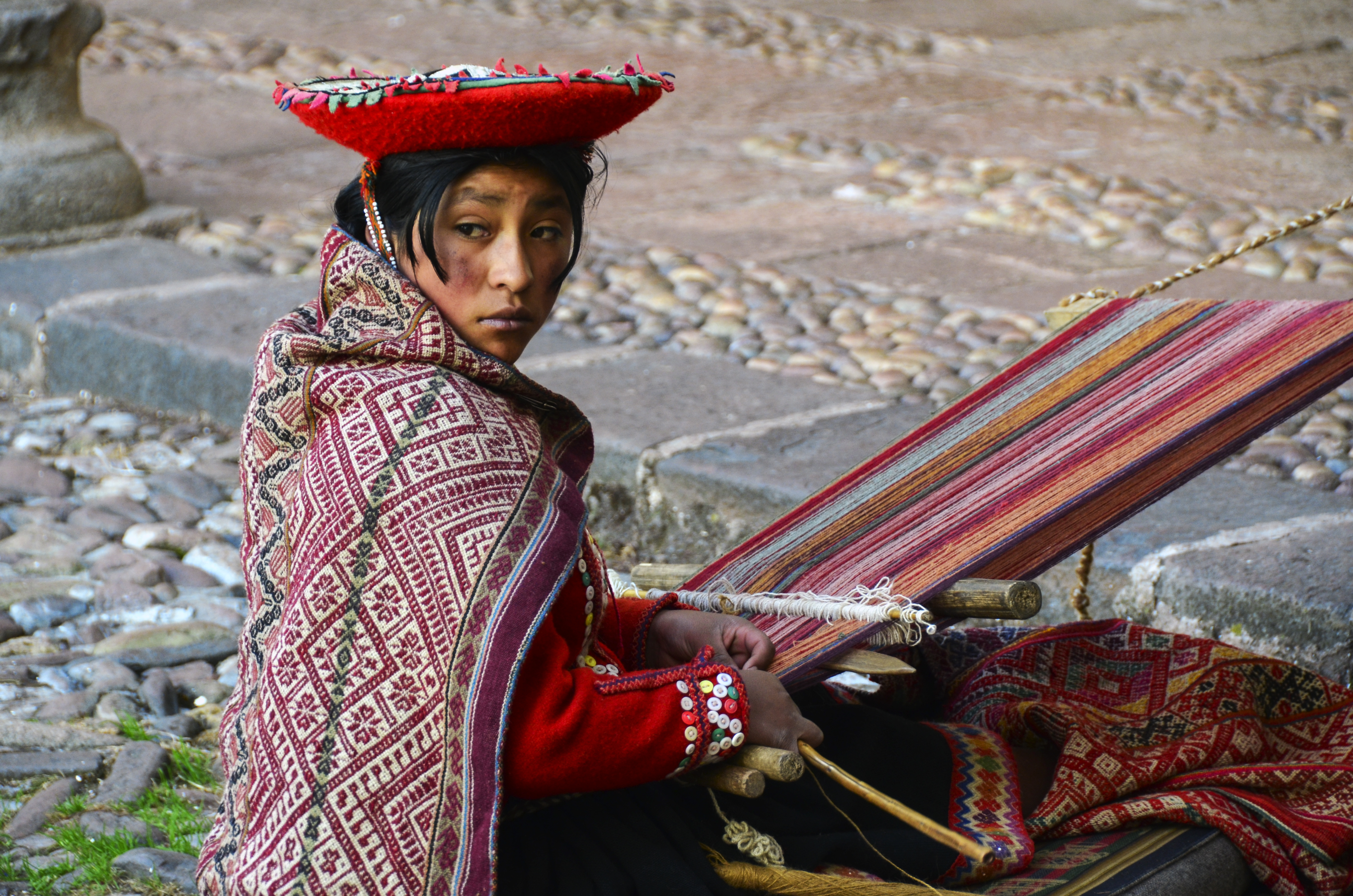 Young artisan weaver in colorful clothing