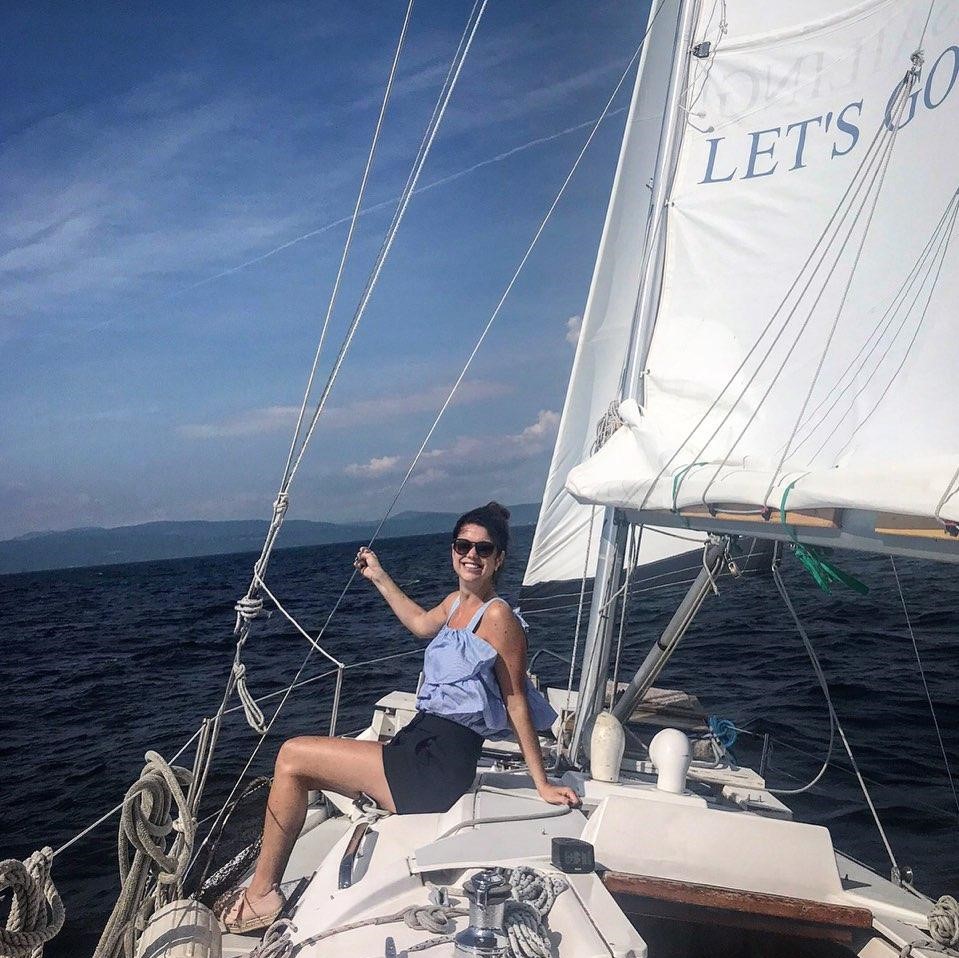 Photo of lauren brennan - a three year occupational therapist - sailing on the open sea.