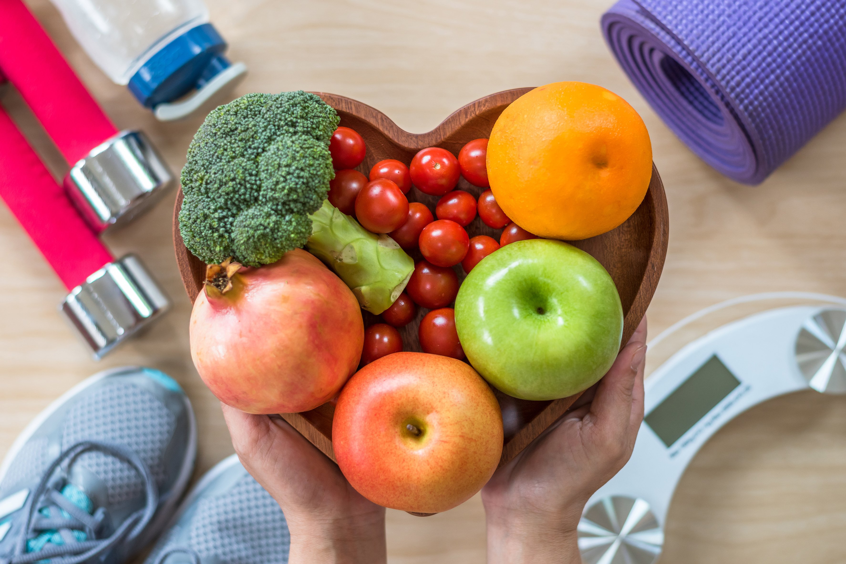 fruits-and-vegetables-in-bowl-around-weights-flatlay