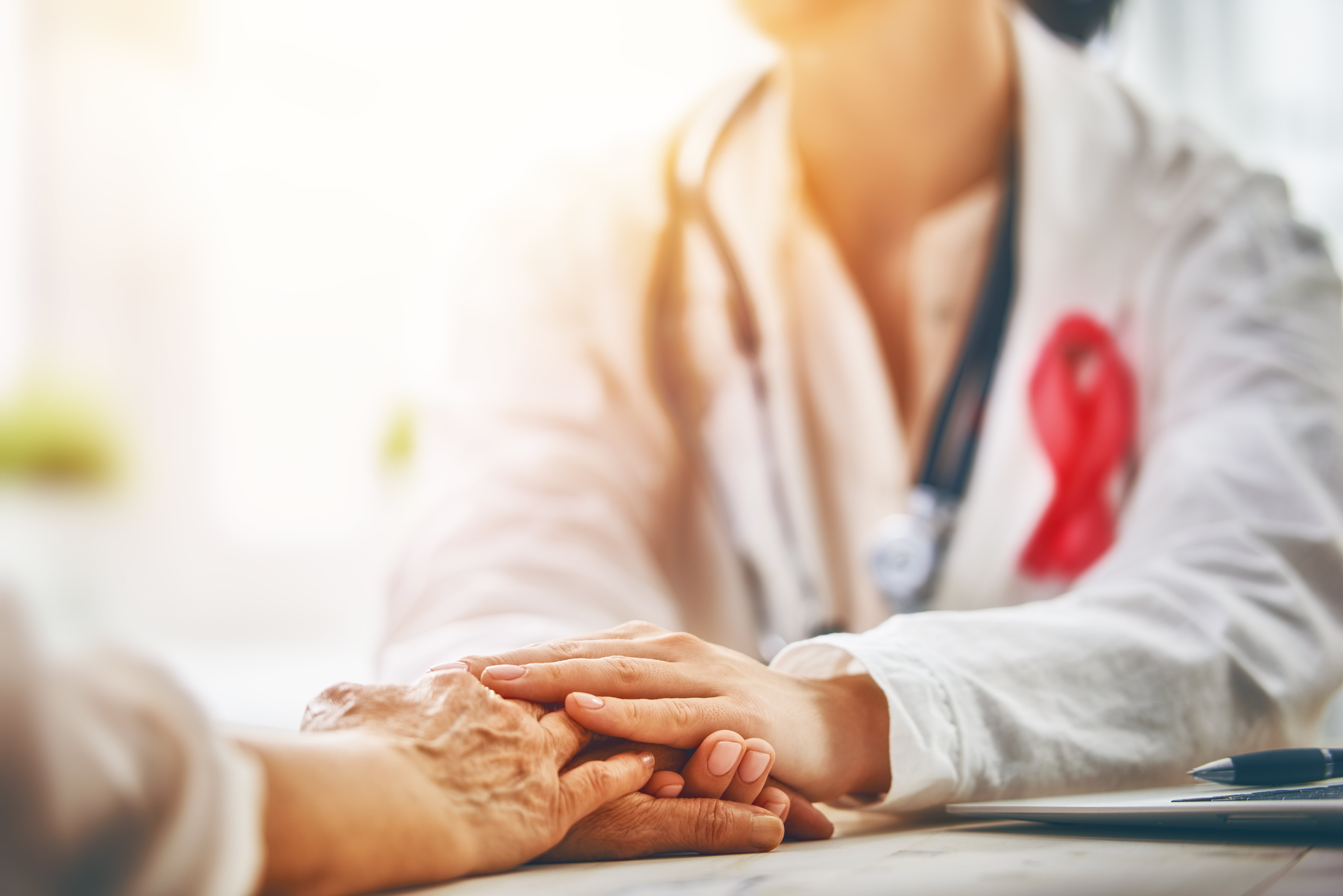 Doctor comforting patients hands