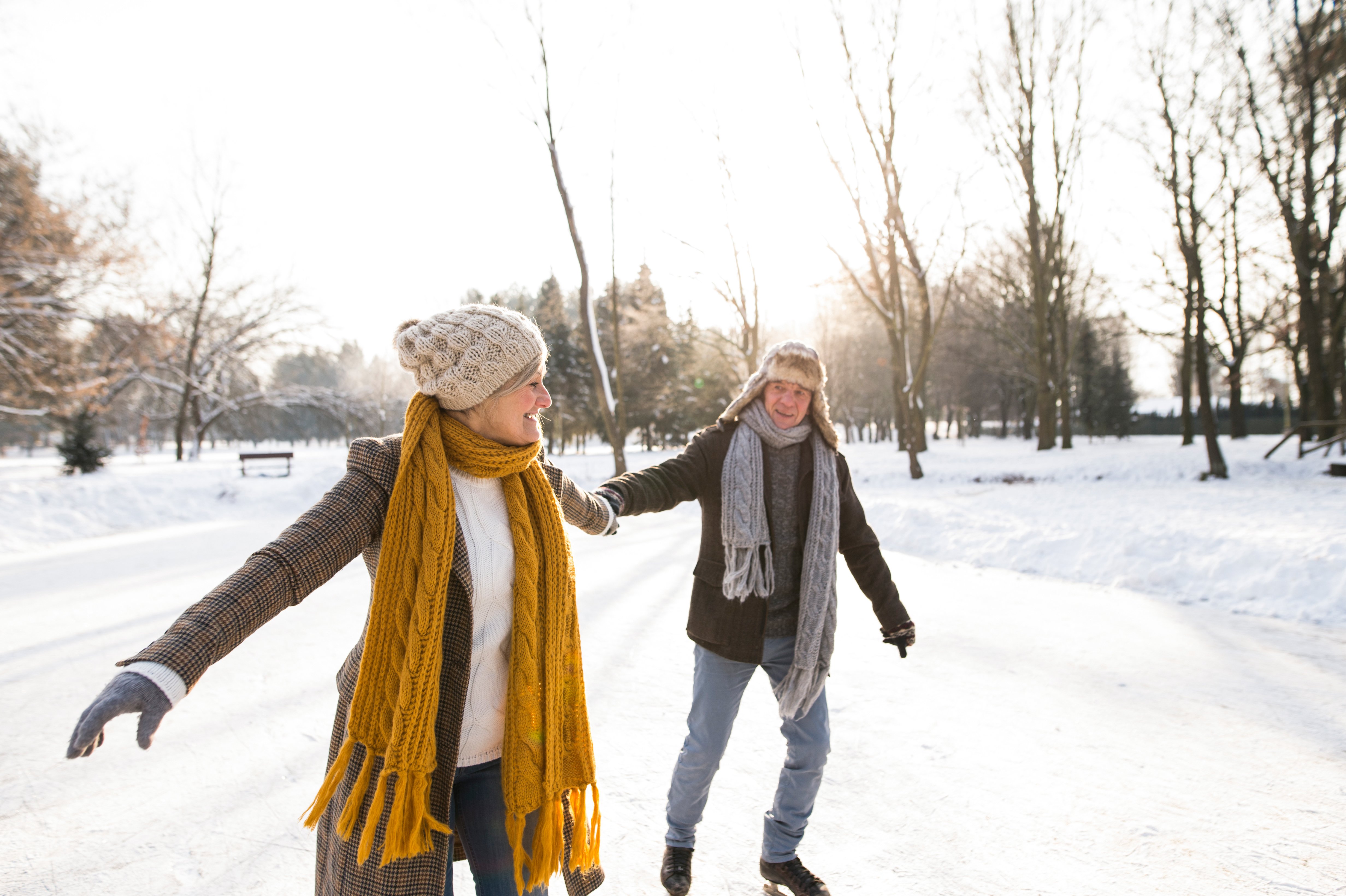 Happy couple skating outdoors