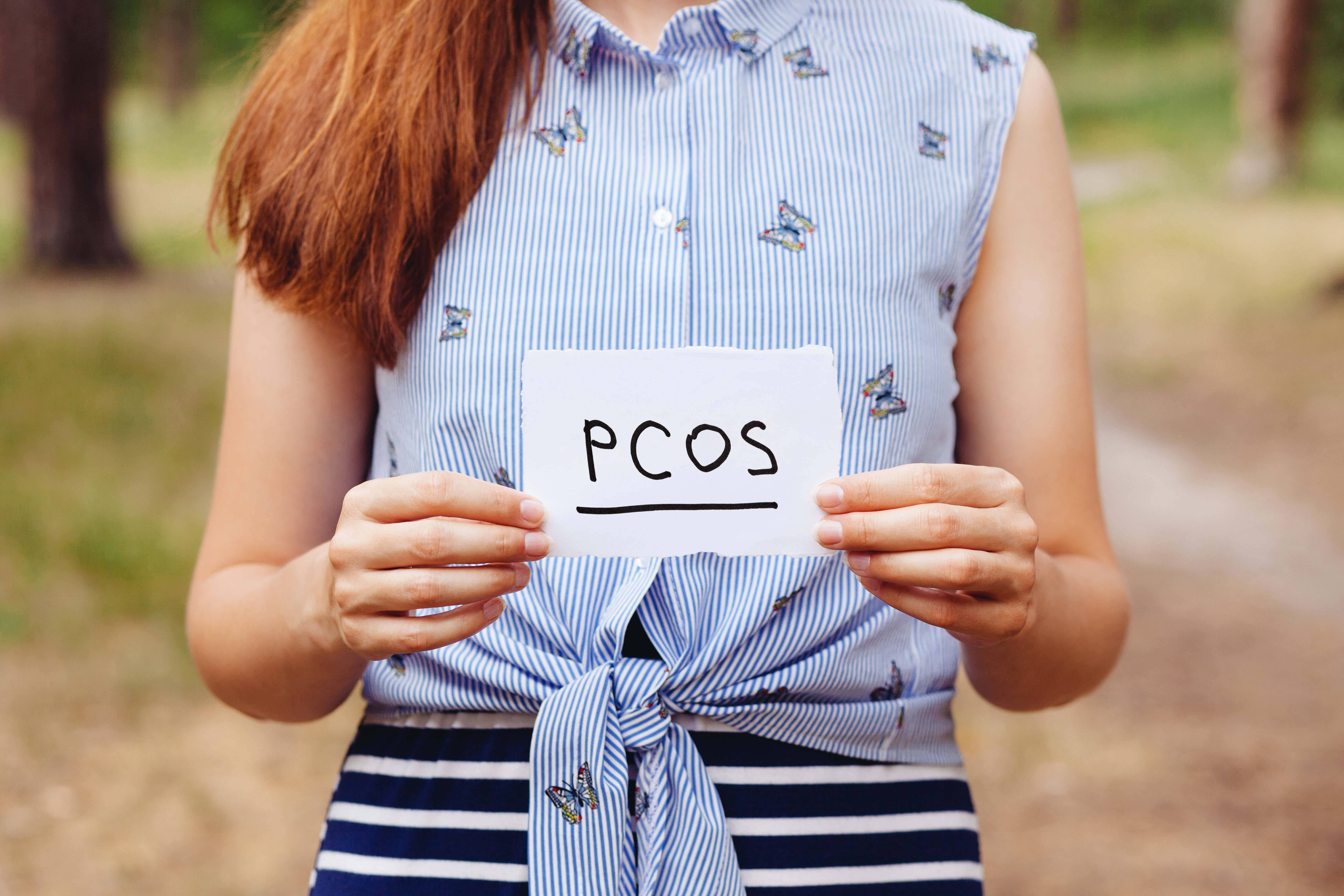 Woman holding PCOS note